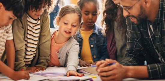 Students doing a creativity project with their teacher in a classroom