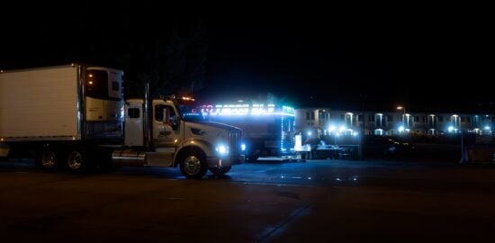 Photo by David Brown: https://www.pexels.com/photo/a-truck-is-parked-at-night-with-lights-on-17720190/