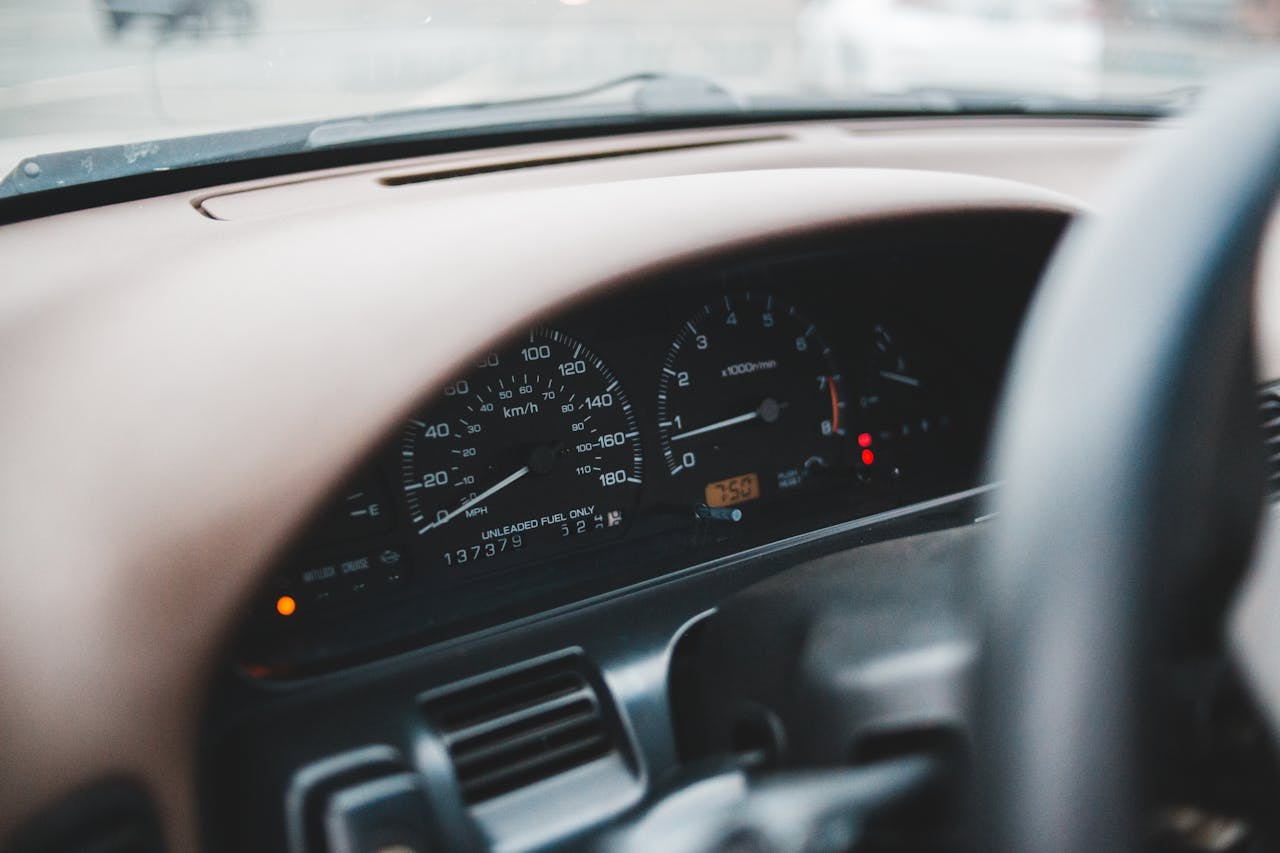 Photo by Erik Mclean: https://www.pexels.com/photo/speedometer-and-part-of-steering-wheel-4991556/