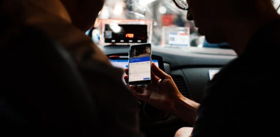 Photo by Rachel Claire: https://www.pexels.com/photo/a-person-holding-a-mobile-phone-inside-the-taxi-7263902/