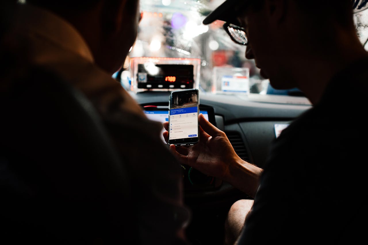 Photo by Rachel Claire: https://www.pexels.com/photo/a-person-holding-a-mobile-phone-inside-the-taxi-7263902/