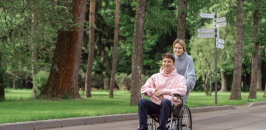 Photo by SHVETS production: https://www.pexels.com/photo/woman-pushing-the-wheelchair-with-a-man-8415730/