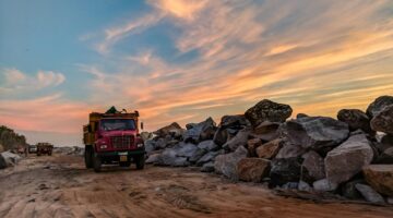 Photo by Guduru Ajay bhargav: https://www.pexels.com/photo/red-dump-truck-near-filed-rocks-under-cloudy-sky-1044290/