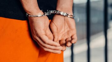 Photo by Kindel Media: https://www.pexels.com/photo/a-person-in-handcuffs-7785046/